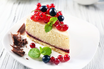 Delicious cheesecake with berries on table close up