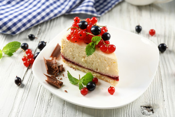 Delicious cheesecake with berries on table close up