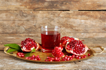 Fresh garnet juice with fruit on wooden background
