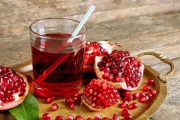 Fresh garnet juice with fruit on table close up