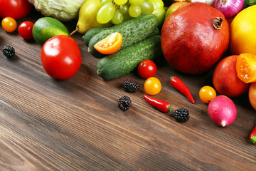 Heap of fruits and vegetables on wooden background