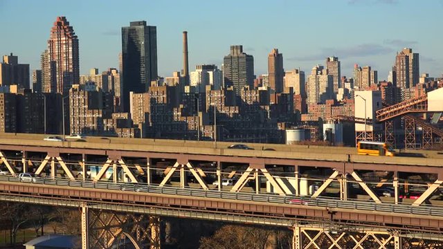 Traffic moves across the Queensboro Bridge with the New York skyline background.