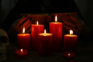 Fototapeta na wymiar Witch - fortune teller with candles close up