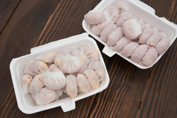 homemade dumpling filled with meat and corn on wooden board