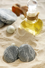 Fototapeta na wymiar Stack of spa stones on sand background