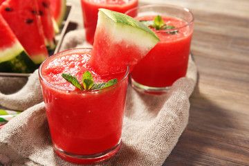 Glasses of watermelon juice on sackcloth, closeup