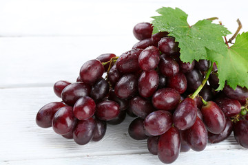 Fresh ripe grapes on wooden table