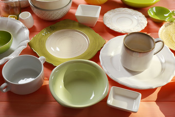 Different tableware on wooden table close up
