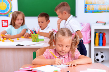 Fototapeta premium Group of children at the desks in classroom