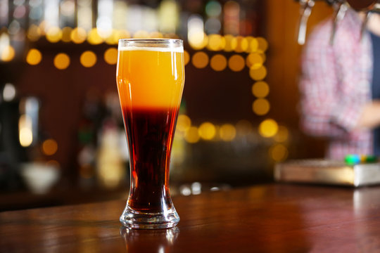 Cold beer glass on bar or pub desk