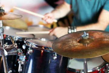 Obraz premium Hand of drummer with sticks and drums, close-up