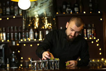 Bartender with tequila glasses