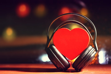 Decorative heart and headphones on lights background