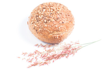Fresh whole grain bread cut in half on white background
