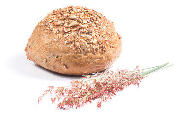 Fresh whole grain bread cut in half on white background
