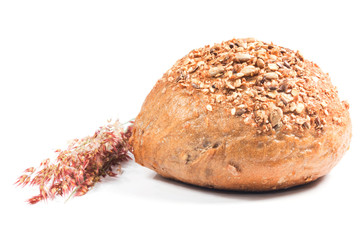 Fresh whole grain bread cut in half on white background
