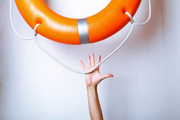 Human hand reaching for life preserver, isolated on white
