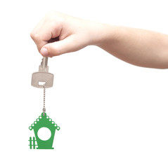 House key in kids hand over white background