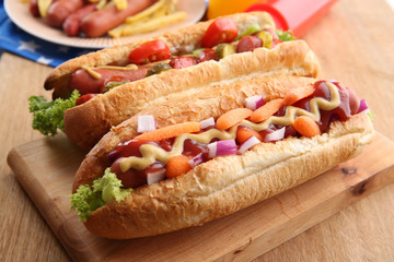 Fresh hot dogs on wooden background