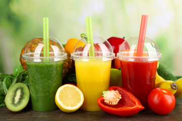Fresh juice mix fruit, healthy drinks on wooden table, on bright background