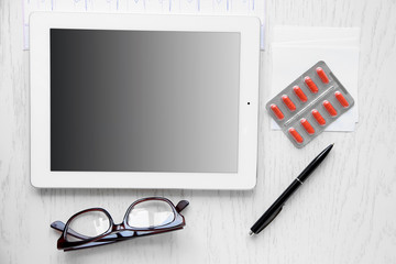 Medical tablet with screen empty screen on wooden table