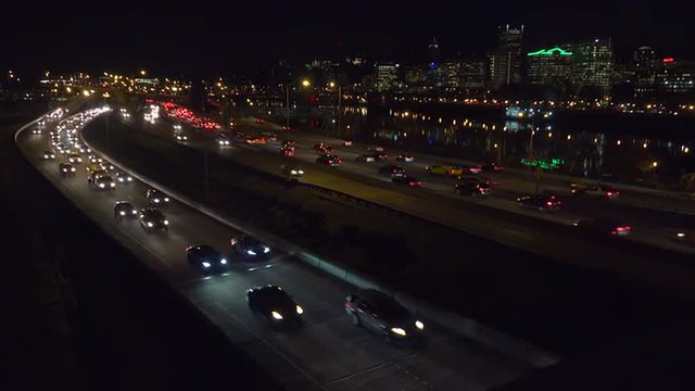 Good footage of freeway or highway traffic at night with the Portland Oregon city skyline background.