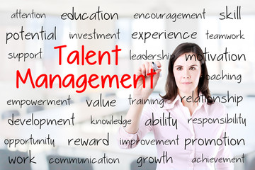 Business woman writing talent management concept. Office background. 