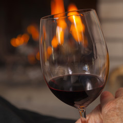 enjoying red wine at fireplace