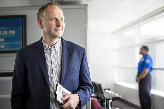 Businessman with passport and boarding pass at the airport