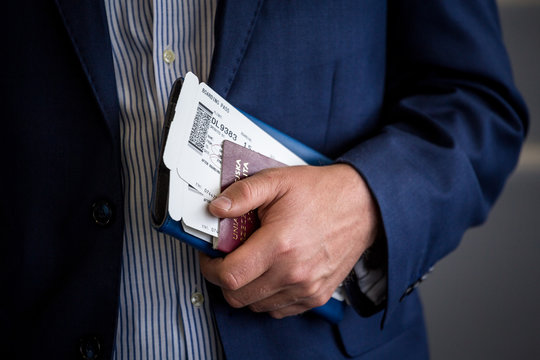 Businessman with passport and boarding pass at the airport