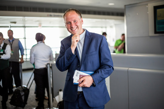 Businessman with passport and boarding pass at the airport