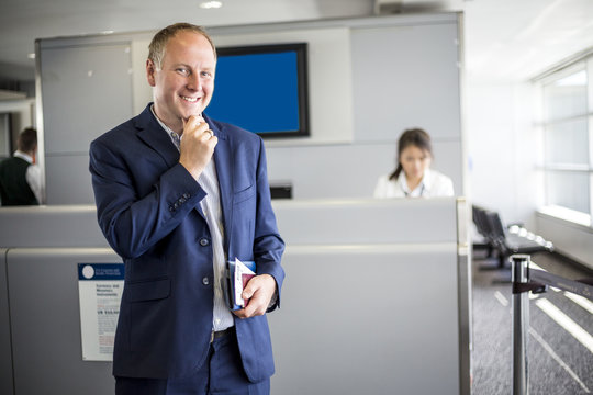 Businessman with passport and boarding pass at the airport