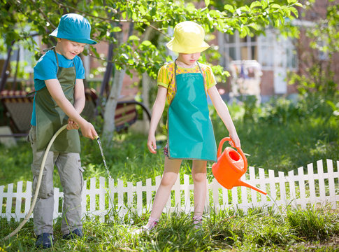 children gardening and watering
