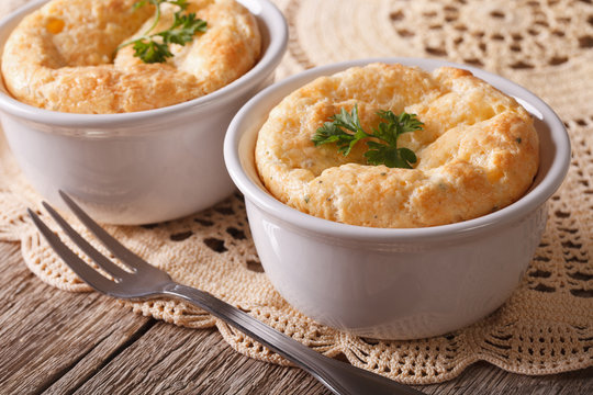 French baked cheese souffle in white rameken close-up. horizontal
