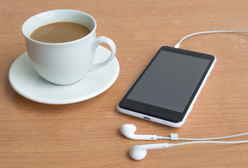 Fototapeta na wymiar Coffee with smartphone and headphones