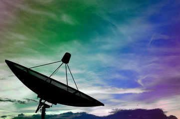 Satellite dish transmission data on colorful cloudy