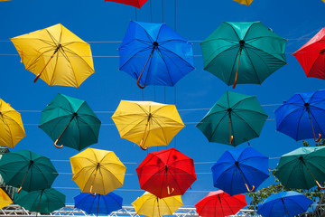 Floating umbrellas. Alley flying umbrellas. Colorful umbrellas in the sky. Fun and bright. Joy and happiness, salvation from the rain.