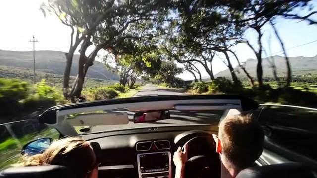 Couple driving convertible car cabriolet cape town south africa steadicam shot