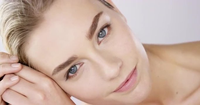 Closeup portrait of beautiful woman face with bright blue eyes slow motion skincare concept - Red Epic Dragon