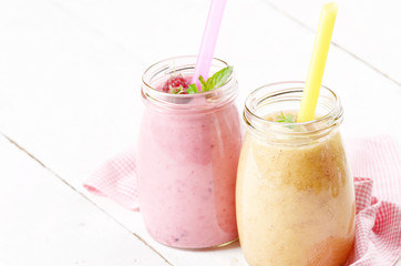 Carrot banana and raspberry shake on wooden table