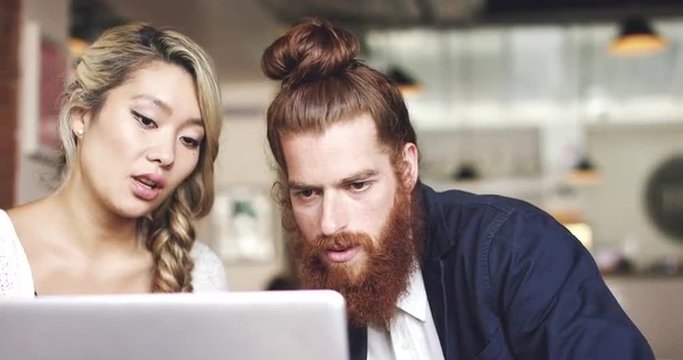 Young couple using digital tablet computer in cafe