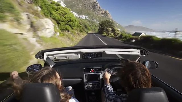 Couple driving convertible car cabriolet cape town south africa steadicam shot