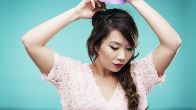 Sad asian woman wearing purple party hat slow motion party photo booth 