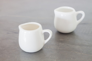 White ceramic pitcher on grey background