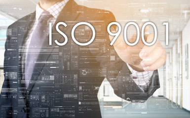 the businessman is choosing ISO 9001 from touch screen
