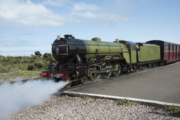 A vintage steam locomotive on a narrow guage track