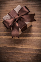 Wrapped present on vintage wood board vertical version holidays 