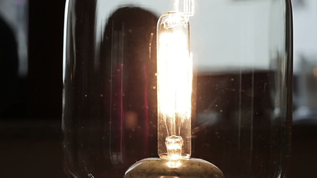 An old light bulb flashes on and of, close up