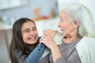 Little girl and grandma whispering secrets