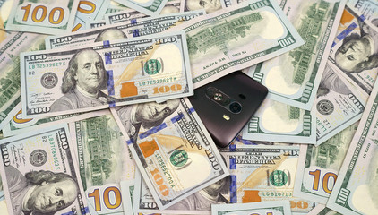 smartphone on dollar bills in american currency 